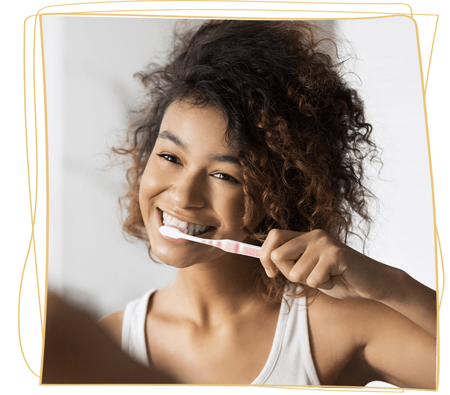 lady brushes her teeth in white tank top
