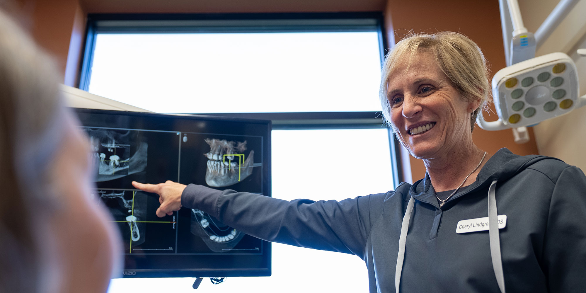 dr points talking to dental patient