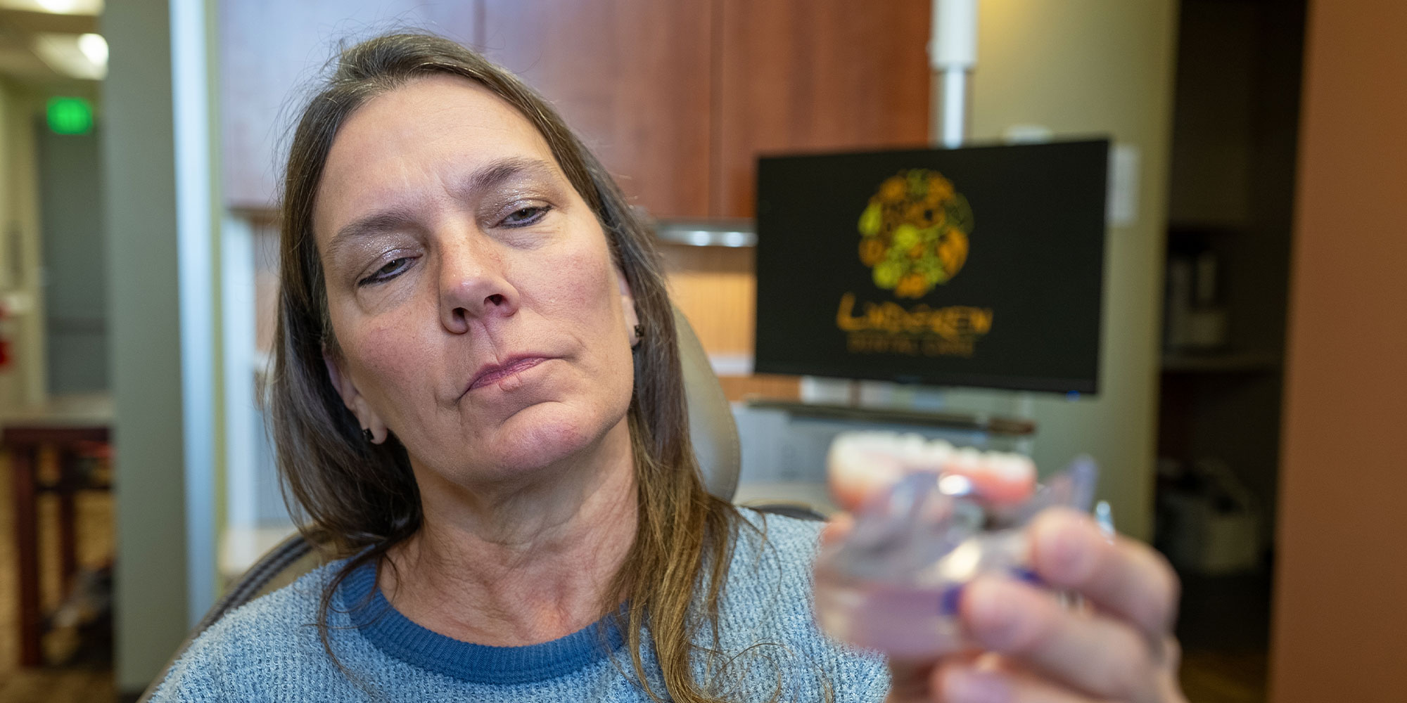 lady looks at dental implants