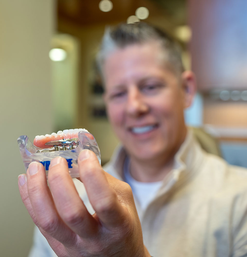 man looking at dental implants