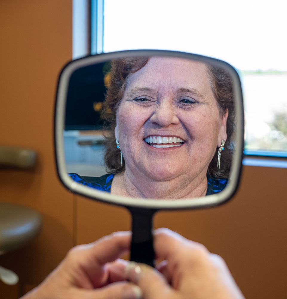 lady in black dress with mirror new smile