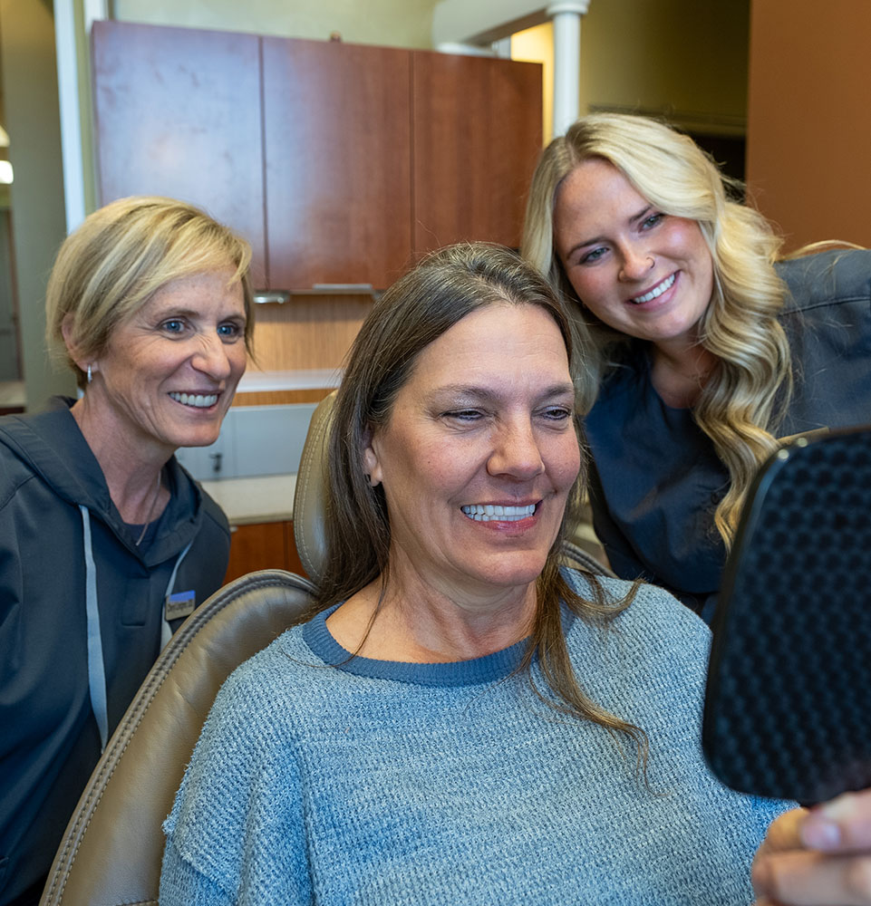 lady with her new smile after dental implants