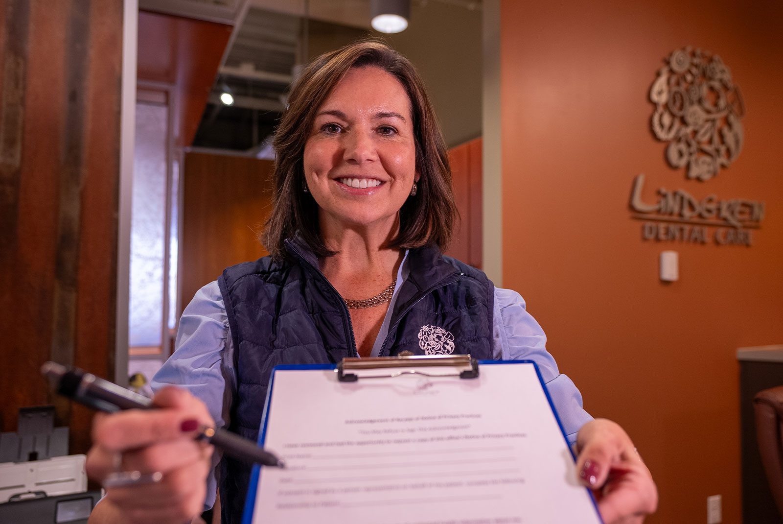 lady with patient forms blue best