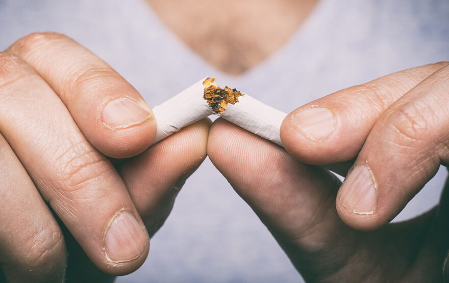 man breaking cigarette